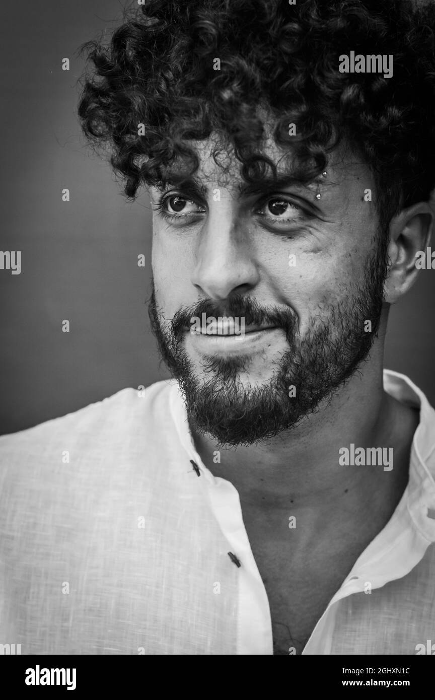 close up portrait in black and white of a young man with a beard and ...