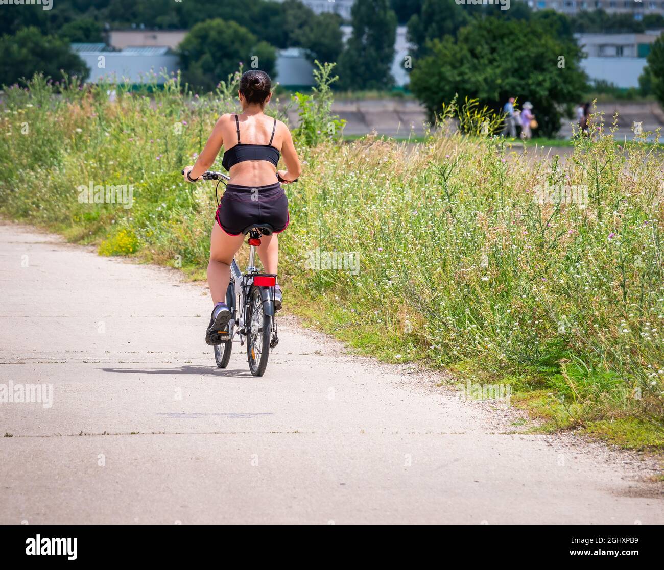 Girl riding bicycle rear view hi-res stock photography and images - Alamy