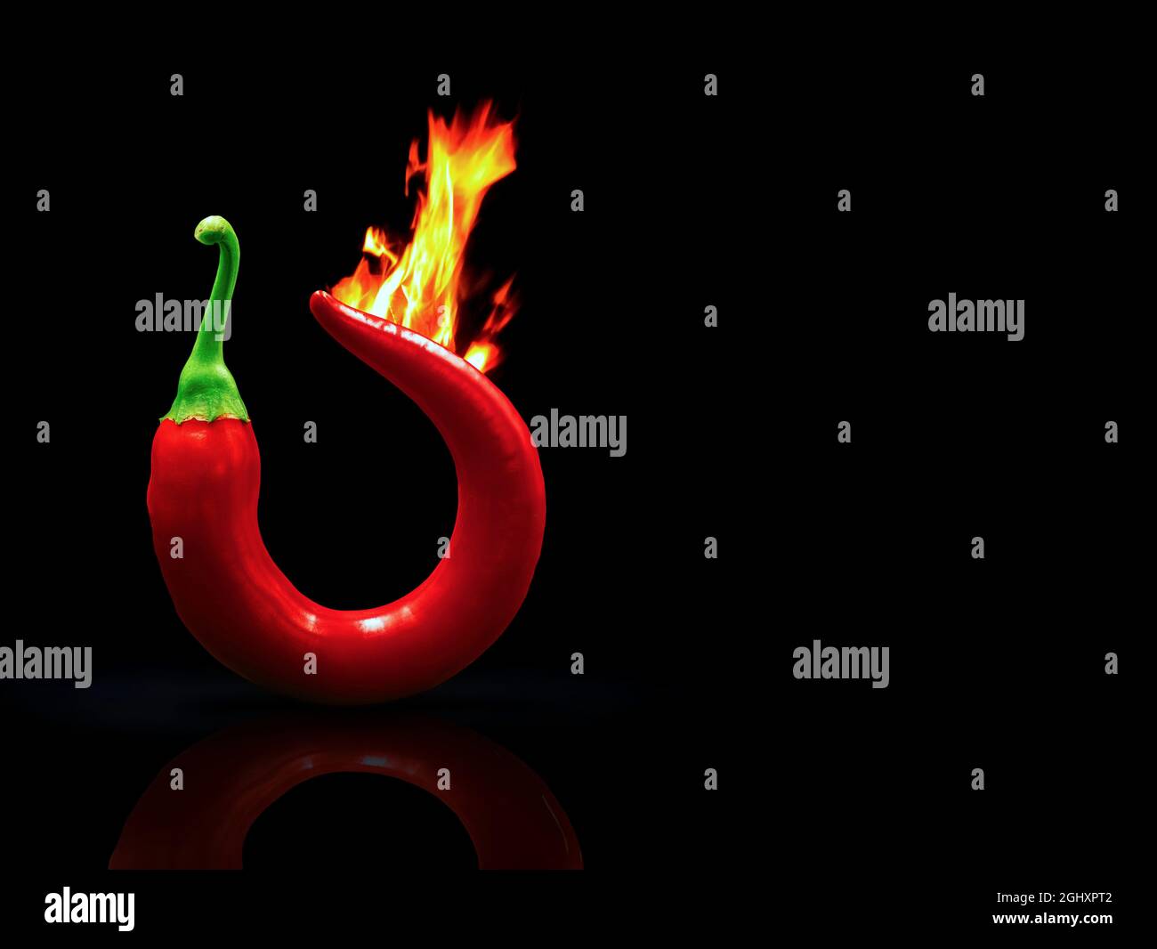 Burning red hot chili pepper isolated on black background with copy space on right side Stock Photo