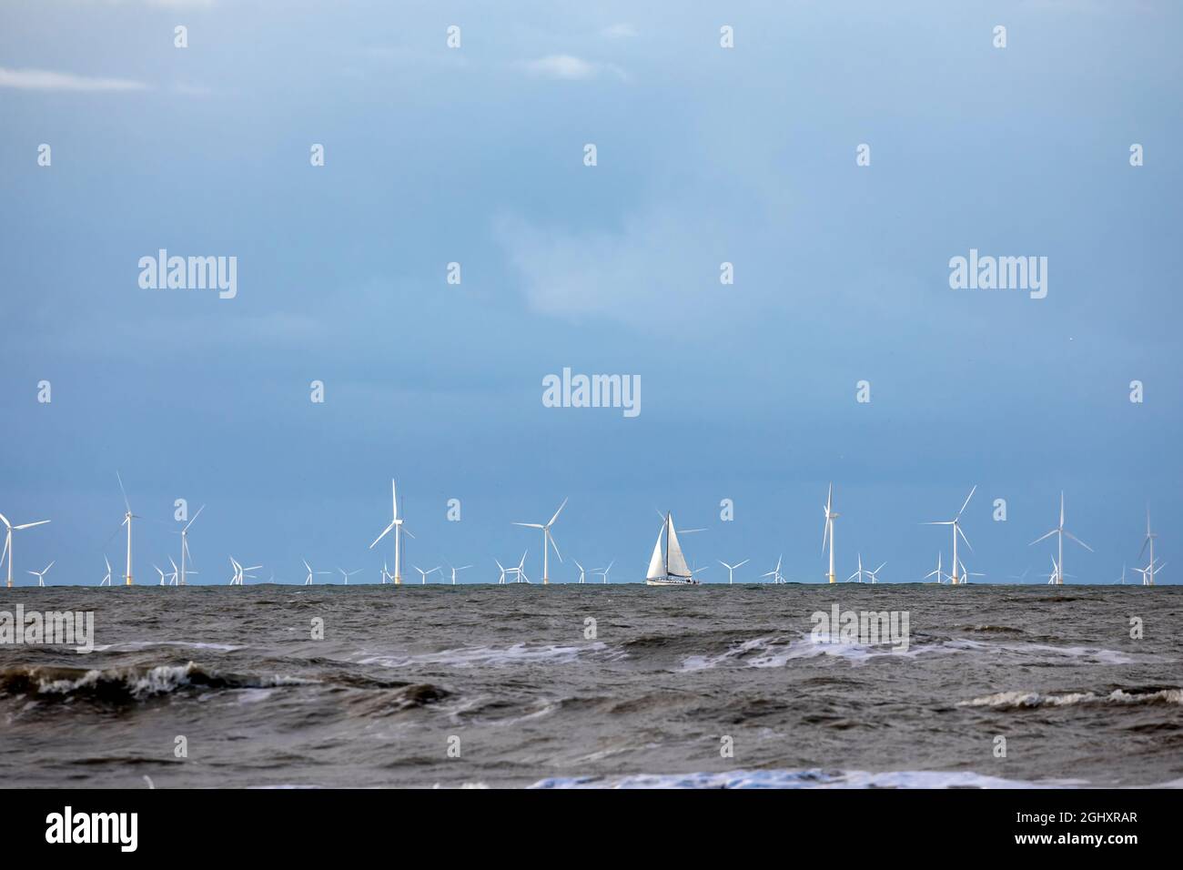 yacht and wind turbines on North sea, Holland Stock Photo