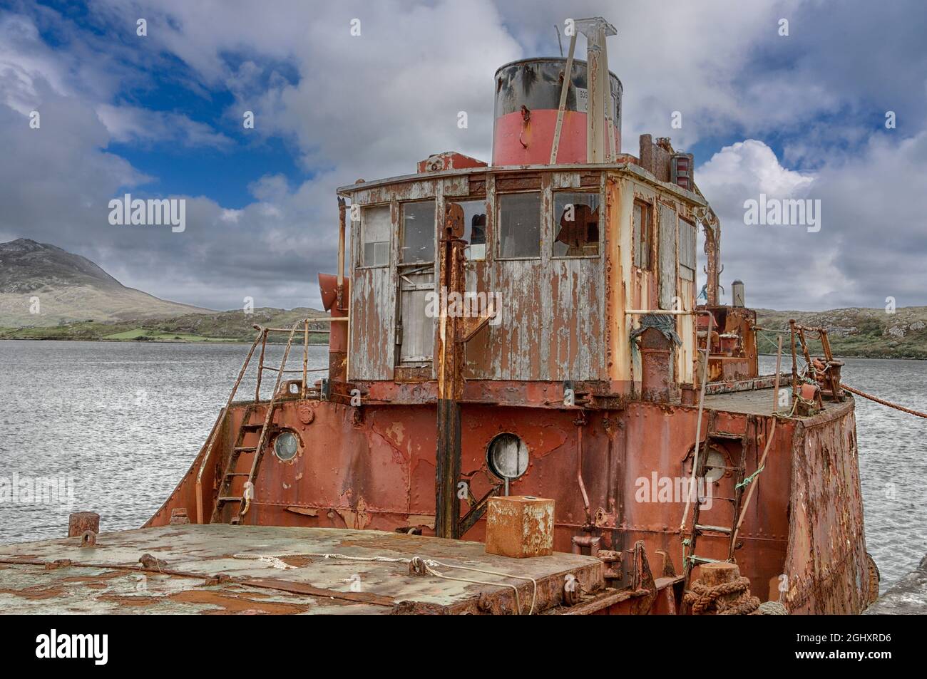 The wreck of a former Clyde puffer called Pibroch moored at Killary Harbour, Connemara, County Galway, Ireland - built as a diesel-engined boat for the Scottish Malt Distillers in Glasgow during 1957. Stock Photo