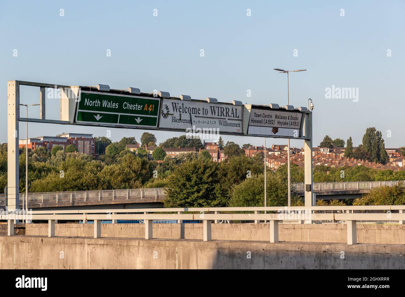 Birkenhead, UK: Welcome to Wirral road sign on A41. Overhead gantry directions to North Wales, Chester, Wallasey and Hoylake. Stock Photo
