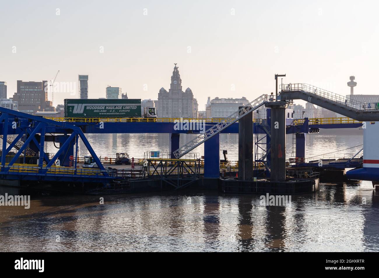 Birkenhead, UK: Vehicles boarding Stena ferry to Belfast at 12 Quays terminal on the river Mersey. Liverpool waterfront buildings in the distance Stock Photo