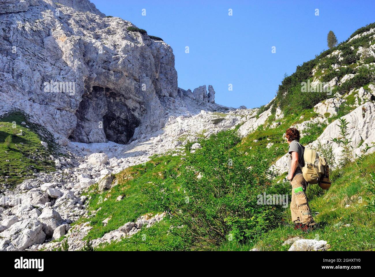 Slovenia, Lepena valley, Triglav National Park. Path for mount Krn and  mount Batognica in a karst environment. North face. A woman trekker. The  demarcated territory by mounts Krn, Batognica and Peski is