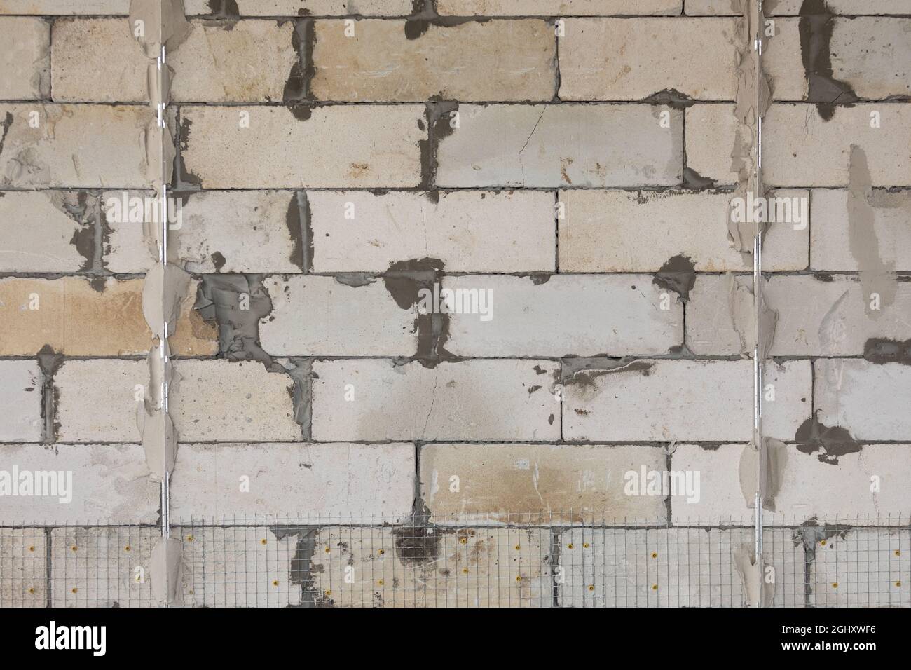 Wall of the foam block. Preparatory work for plastering walls inside the building Stock Photo
