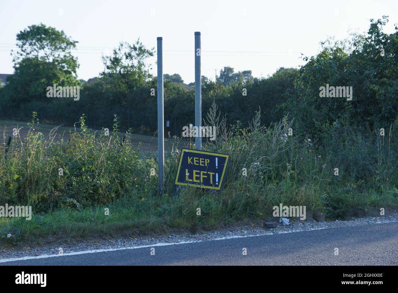'Keep Left' warning sign on the B4031 outside of RAF Croughton, Northamptonshire. Stock Photo
