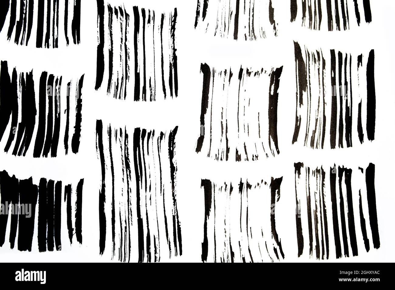 Black abstract brush strokes pattern and splashes of paint on paper. Grunge art calligraphy background texture Stock Photo