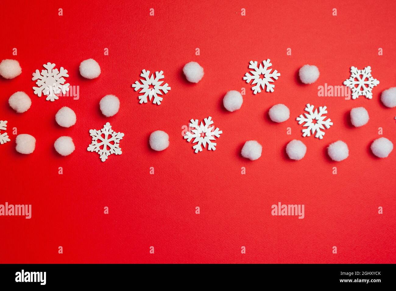 Christmas and Happy New Year greeting card with line of snowflakes on red backgroun. Xmas holiday postcard with place for your text Stock Photo