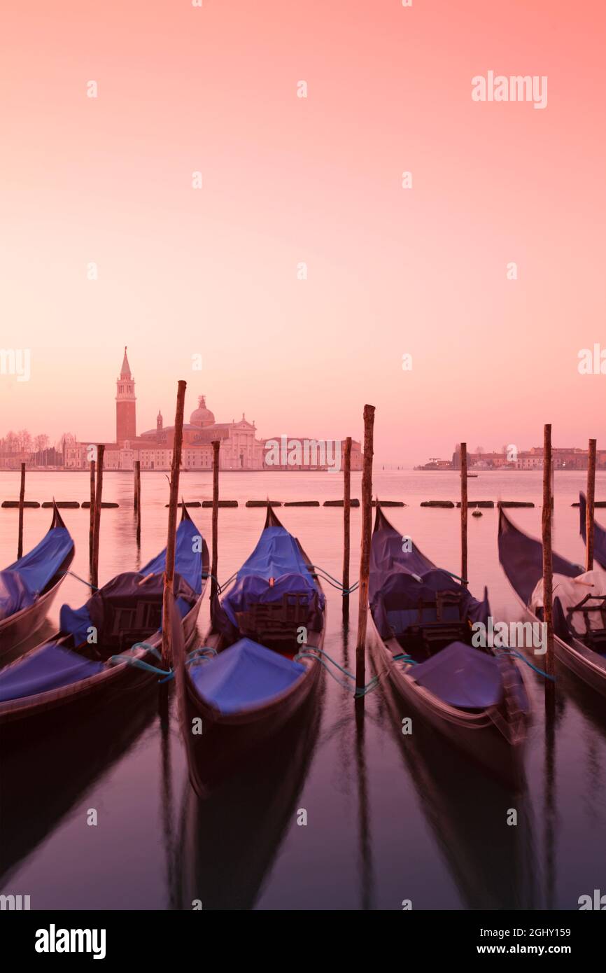 Gondolas in St. Mark's square with Saint George's island at sunrise, Venice, Italy Stock Photo