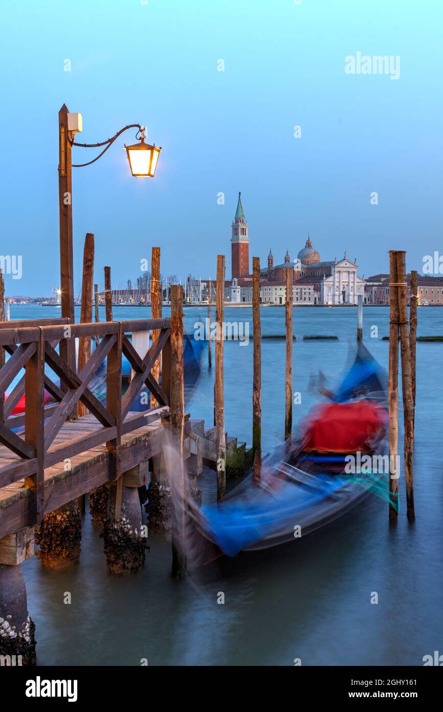 Gondolas in St. Mark's square with Saint George's island at sunrise, Venice, Italy Stock Photo