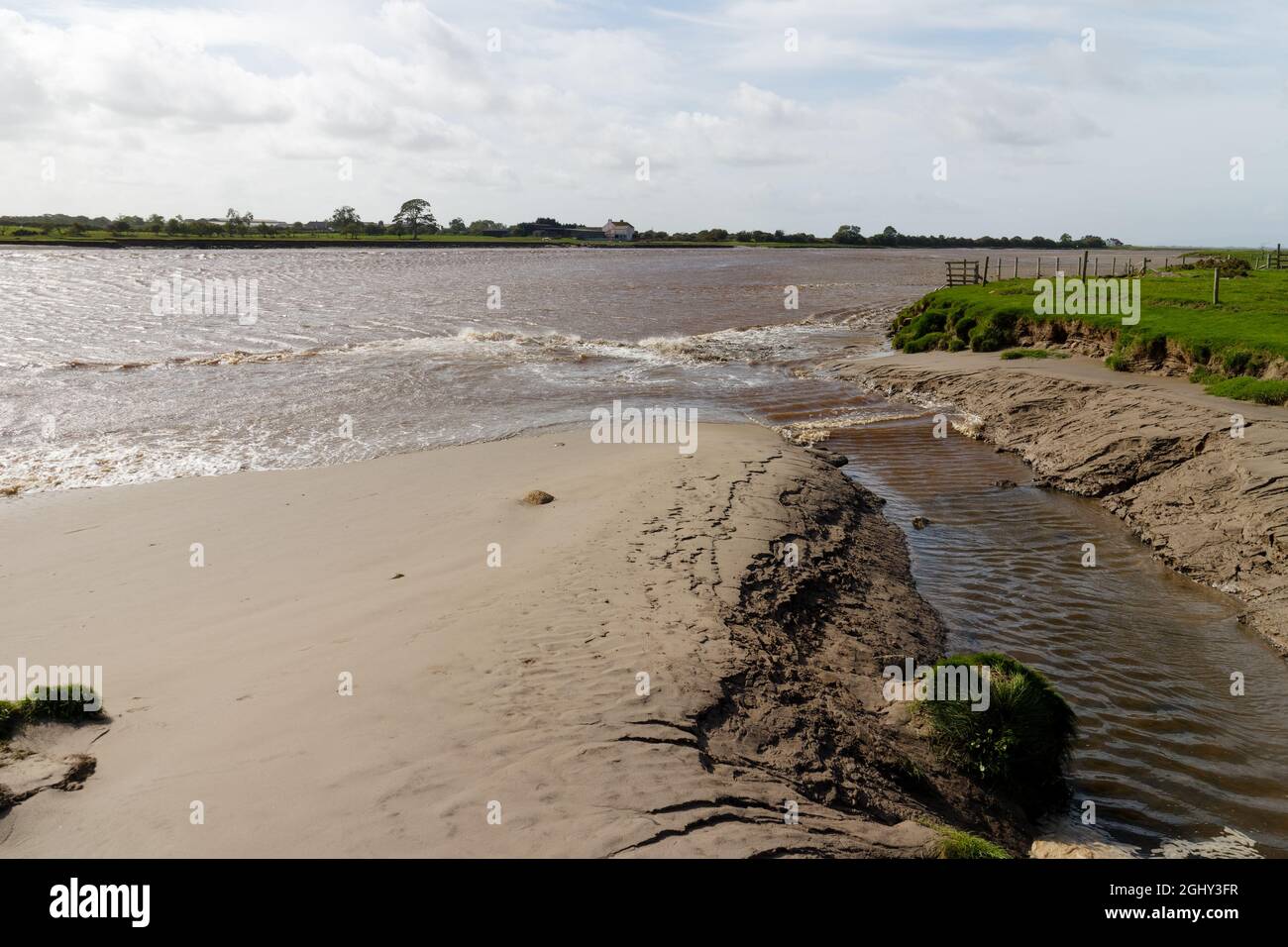 A secondary wave of the Solway Bore entering a small channel near Rockcliffe Marsh Stock Photo