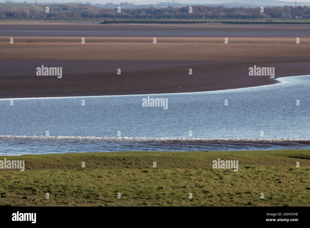 The Solway Bore heading inland up the low tide channel of the River Eden Stock Photo