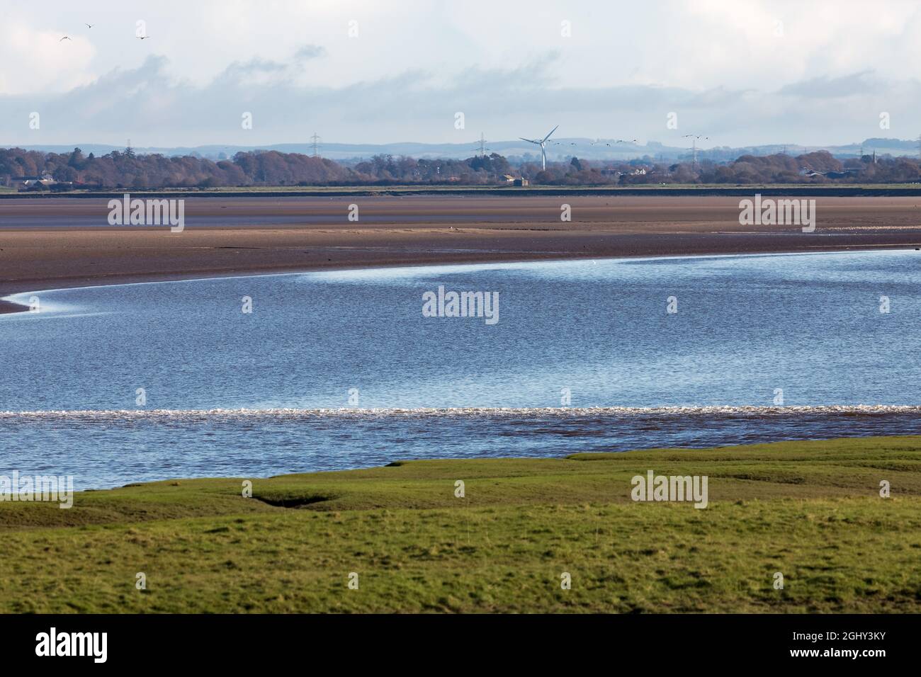 The Solway Bore heading inland up the low tide channel of the River Eden Stock Photo