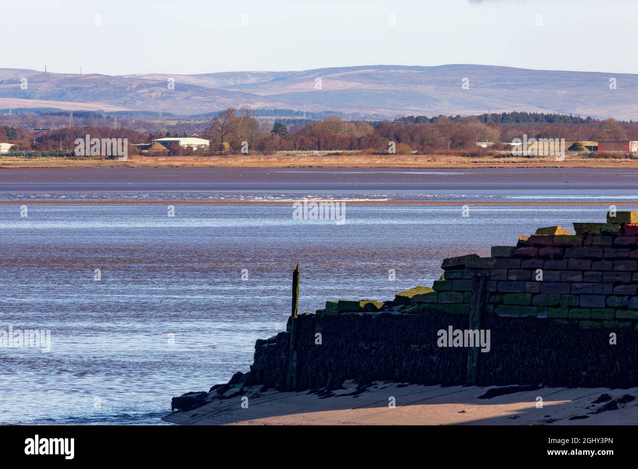 The Solway Bore passing the old harbour at Port Carlisle Stock Photo