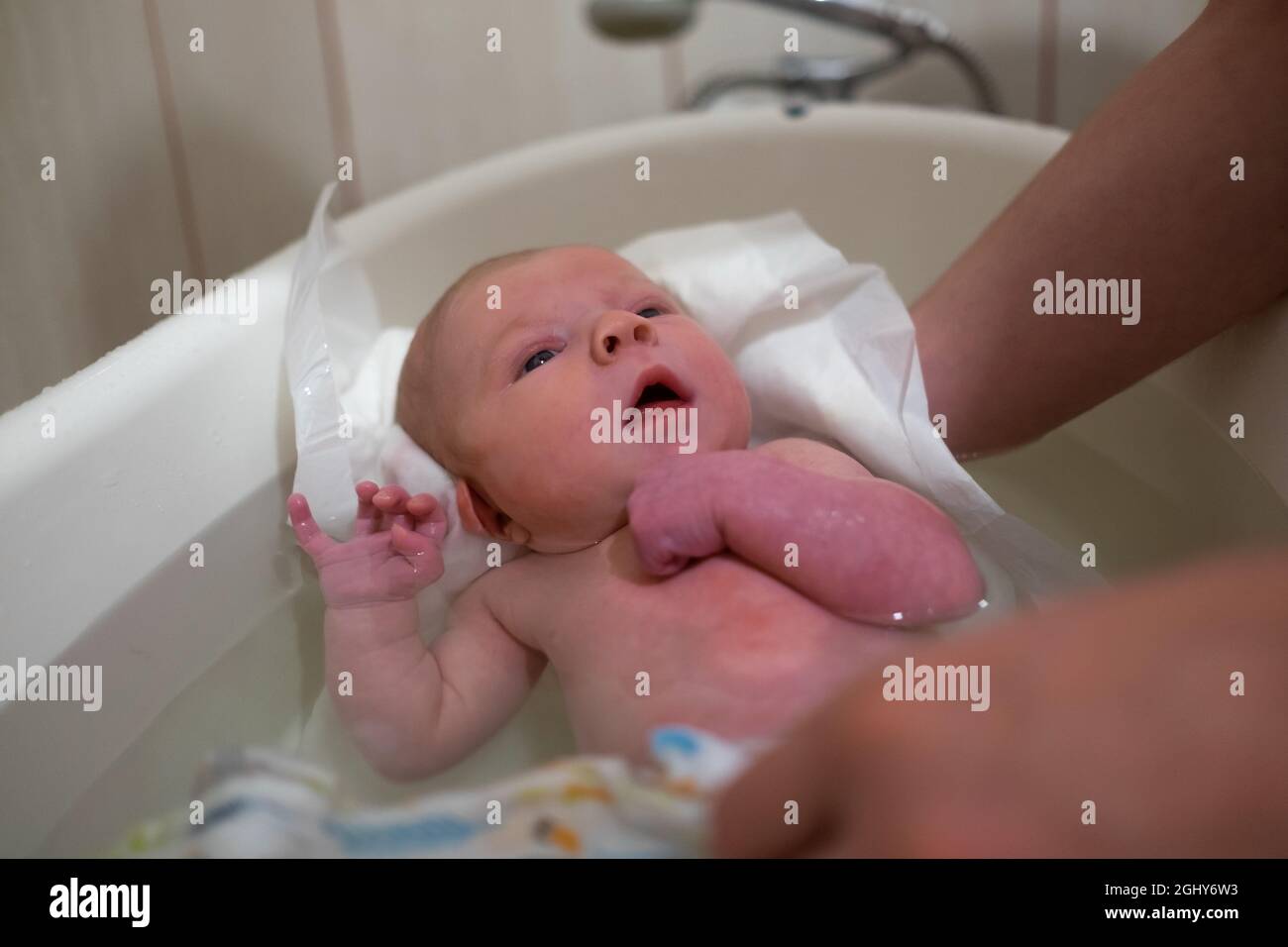 First bathing of a newborn baby girl at home Stock Photo Alamy
