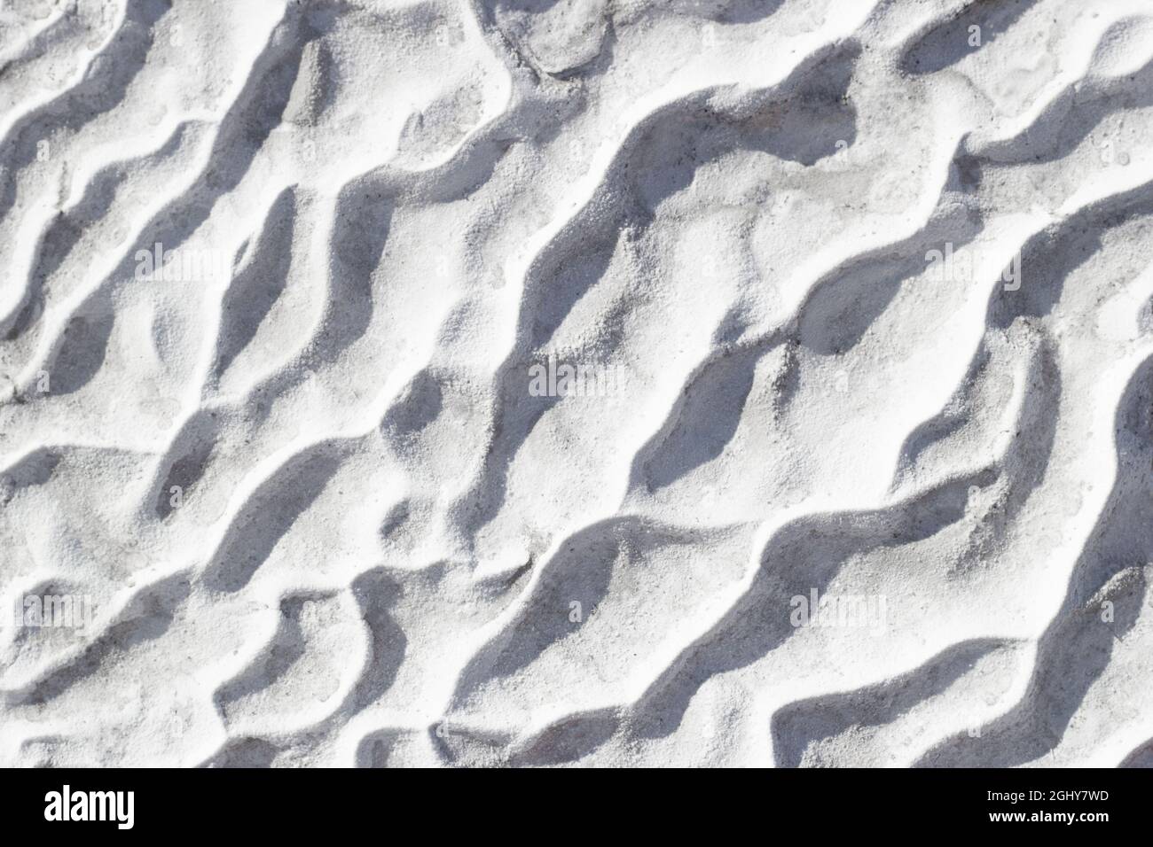 Gray texture background of Pamukkale calcium travertine in Turkey, pattern of diagonal waves, close-up. Stock Photo