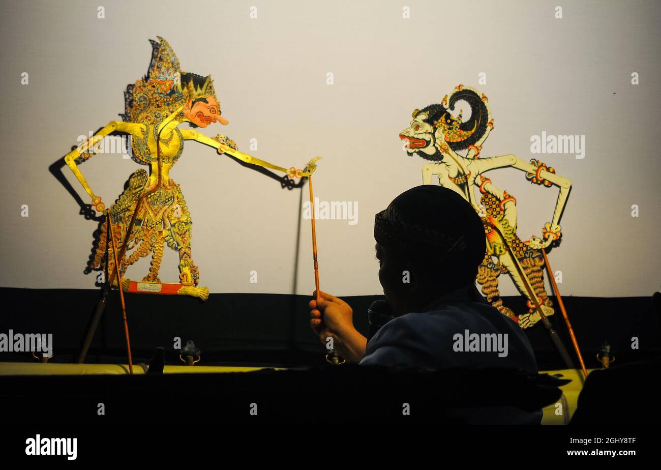 Javanese shadow puppet show. Shadow puppets are usually staged from evening until early morning and are free to be watched by the general public. Stock Photo