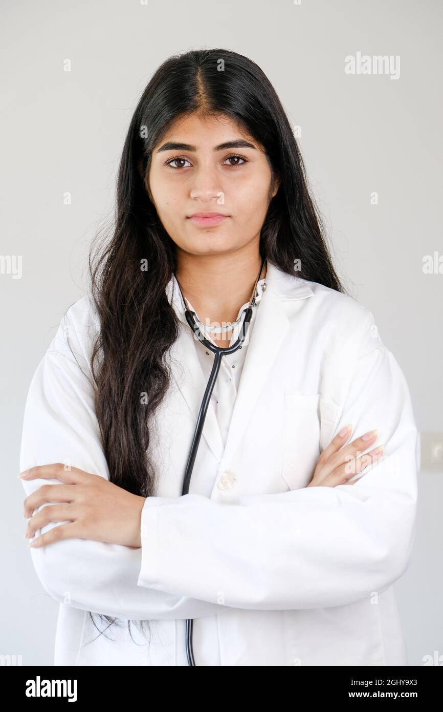 Young Indian female doctor wearing white coat and stethoscope standing ...