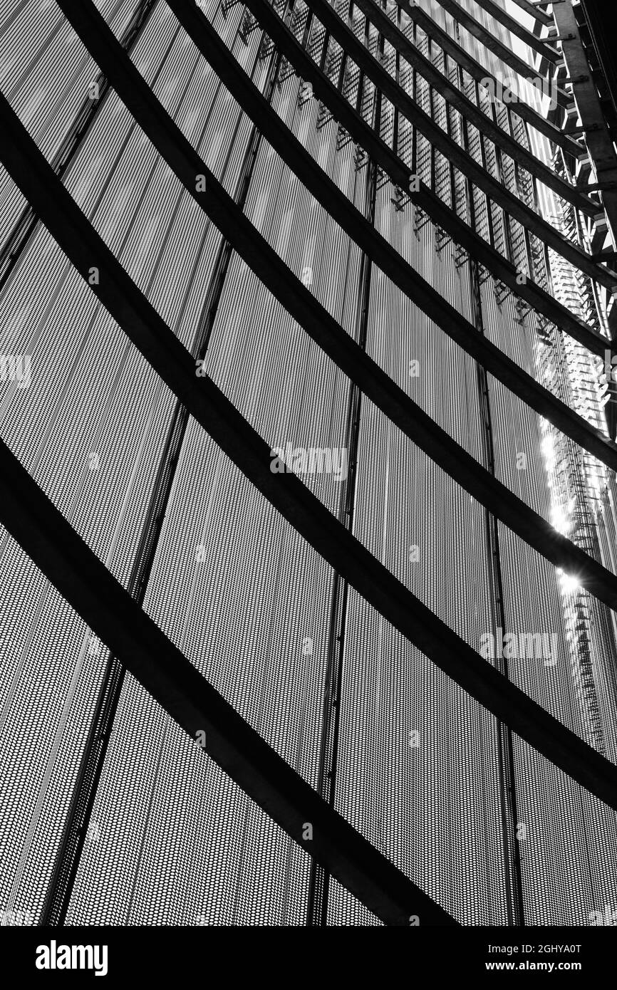 Metallic screen with arched support forming abstract urban facade in black and white Stock Photo