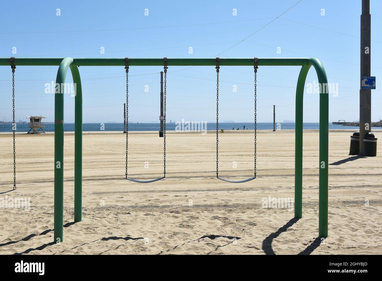 SAN PEDRO, CALIFORNIA - 27 AUG 2021: Swing Set in a sand  playground at Cabrillo Beach Stock Photo