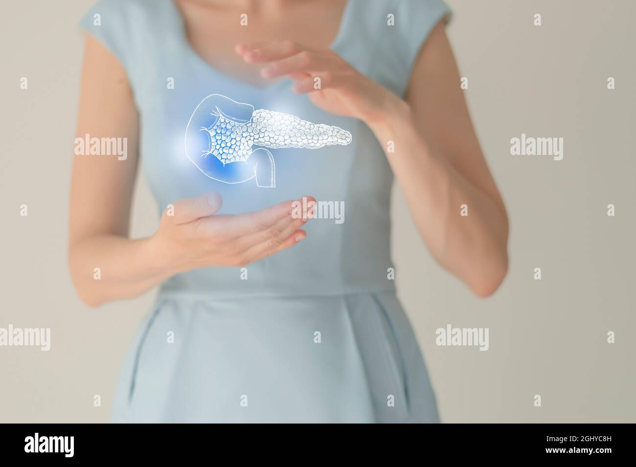 Unrecognizable female patient in blue clothes, highlighted handrawn pancreas. Human digestive system issues concept. Stock Photo