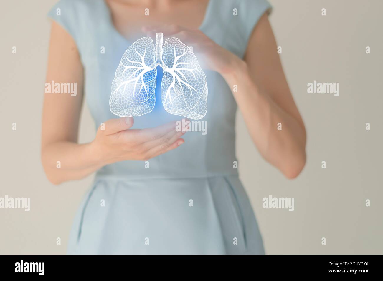 Unrecognizable female patient in blue clothes, highlighted handrawn lungs. Human respiratory system issues concept. Stock Photo