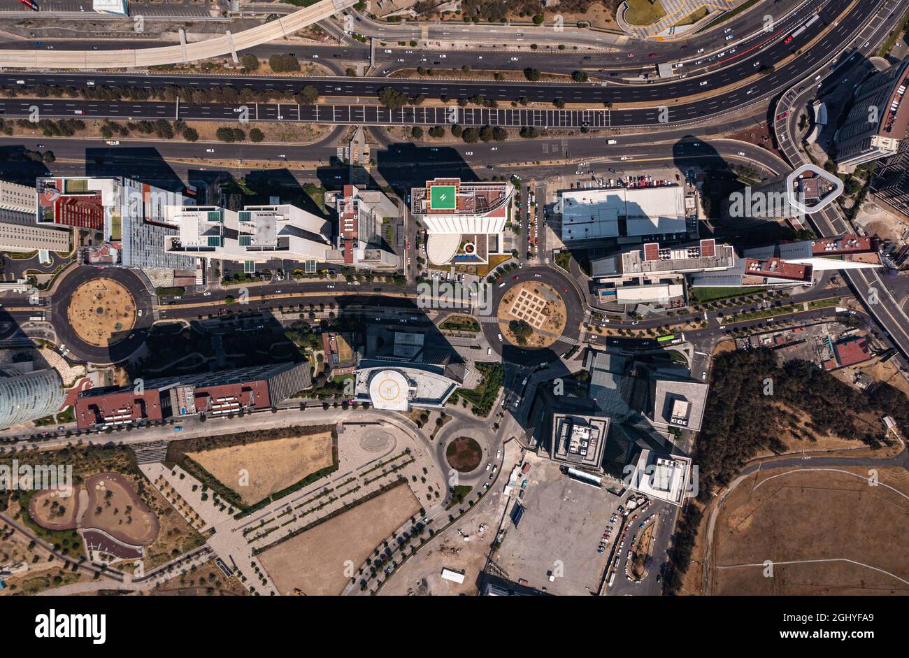 Birds eye view of rooftop of building and skyscrapers with empty street and road in Santa Fe which is the New neighbourhood in Mexico City during day Stock Photo