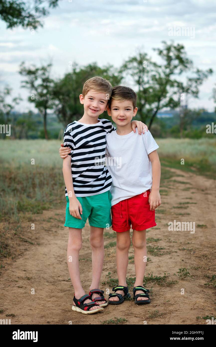 Two happy little kids boys embracing in rural settings. Funny ...
