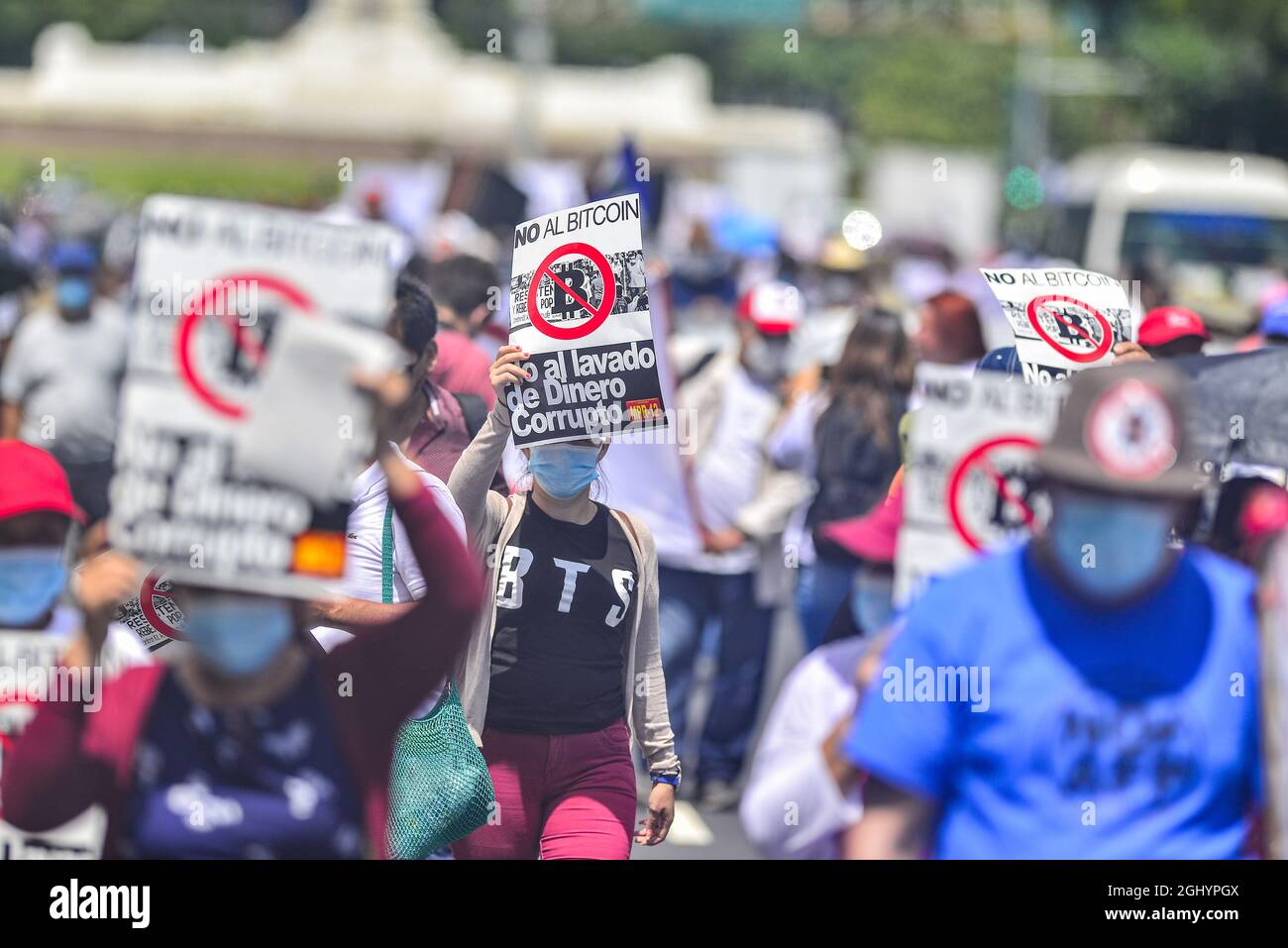 San Salvador, El Salvador. 07th Sep, 2021. A demonstrator holds an anti- bitcoin banner while chanting anti-government slogans on a megaphone during  the protest march. Thousands of Salvadorans took to the street to