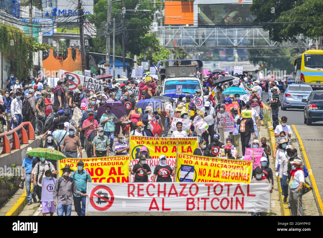 San Salvador, El Salvador. 07th Sep, 2021. Demonstrators march while  holding anti-bitcoin signs during the protest march in San Salvador.  Thousands of Salvadorans took to the street to reject the Bitcoin law