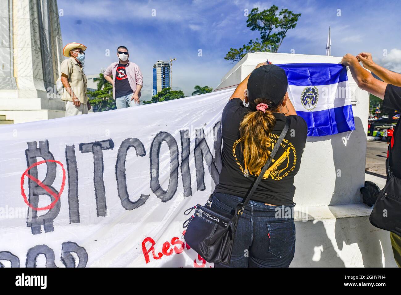San Salvador, El Salvador. 07th Sep, 2021. A demonstrator pins up a  Salvadoran flag during the demonstration. Thousands of Salvadorans took to  the street to reject the Bitcoin law previously passed by