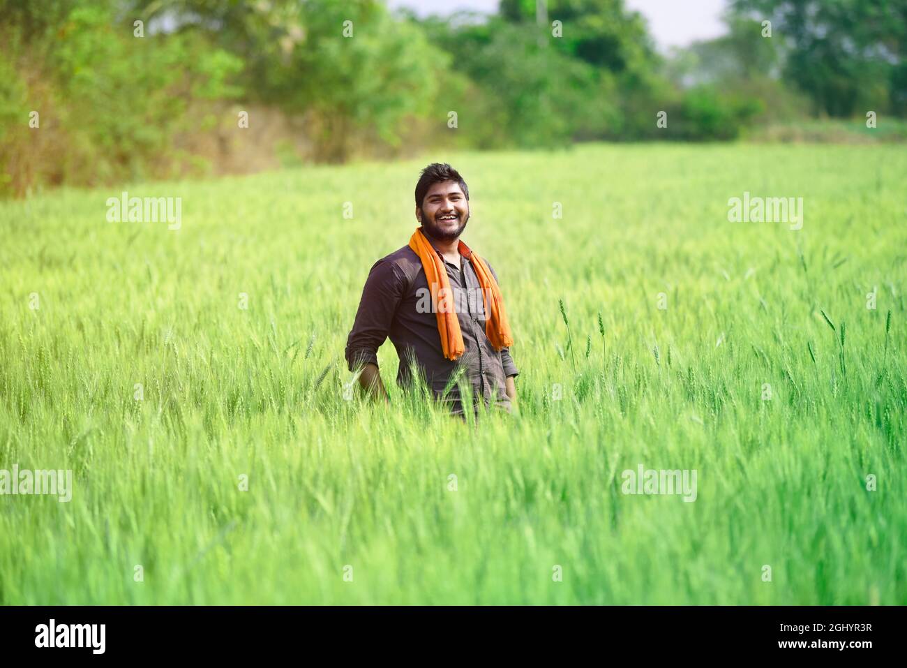 Indian farmer with empty hand for product putting and pointing finger at empty hand Stock Photo