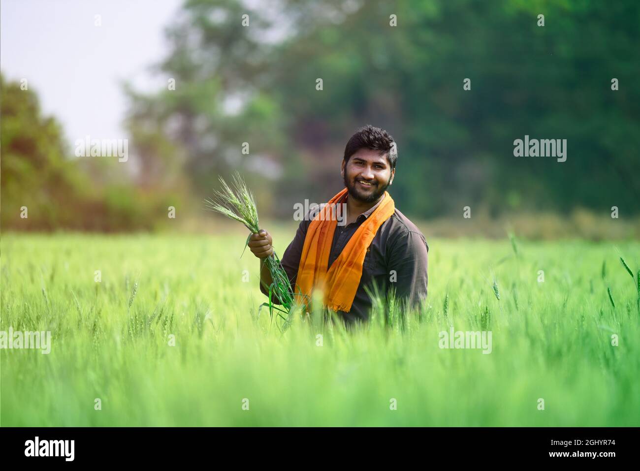 Indian farmer with empty hand for product putting and pointing finger at empty hand Stock Photo