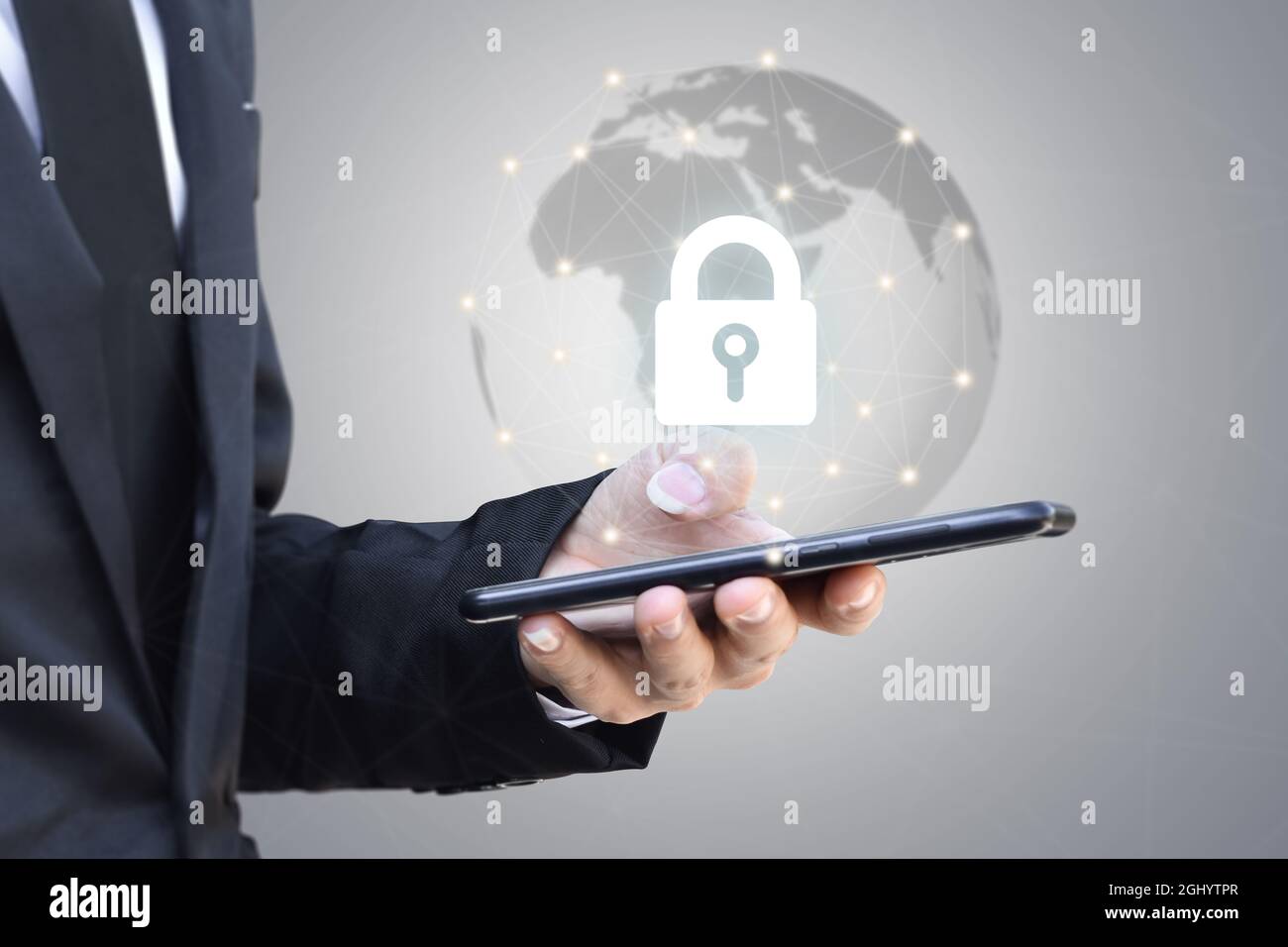 Businessman holding mobile phone with shield lock. Cyber security data protection and information technology network concept. Stock Photo