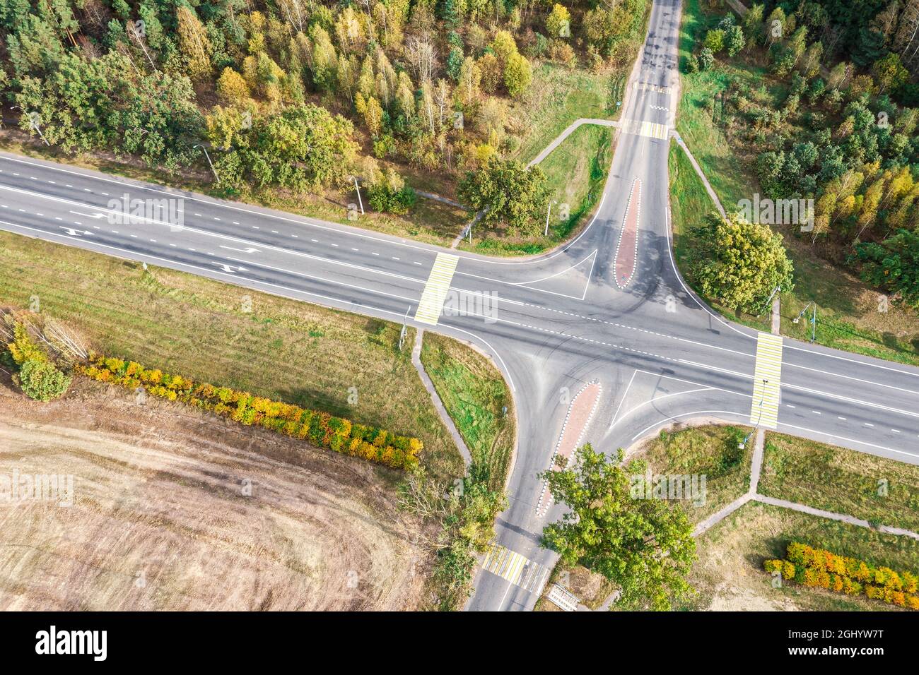 aerial view of the country roads intersection in rural landscape with forest and farmlands Stock Photo