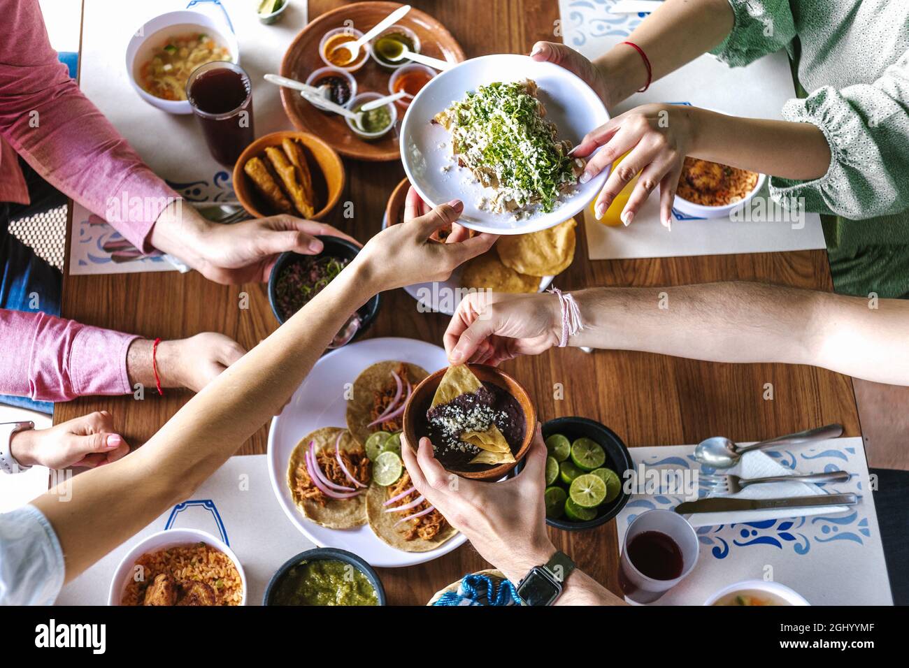 Group Of Friend Eating Mexican Tacos And Traditional Food Snacks And Peoples Hands Over Table Top View Mexican Cuisine Stock Photo Alamy