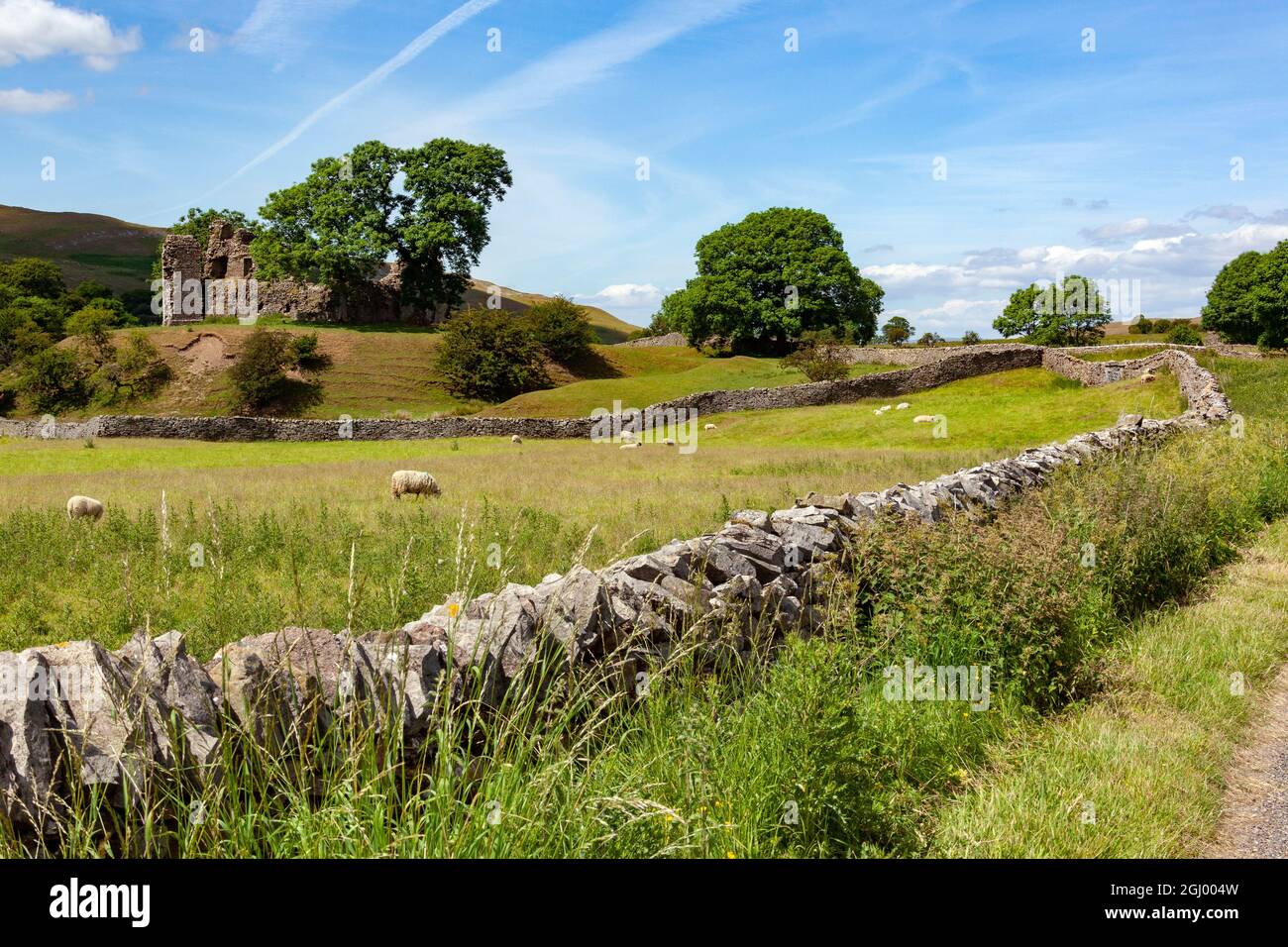 Traditional dry-stone walls and the ruins of an old castle in the ...