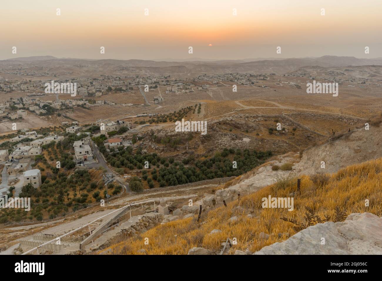 Sunrise view towards the Judaean desert and the Dead Sea, with a herd of sheep and Palestinian villages. From Herodium, the West Bank, South of Jerusa Stock Photo