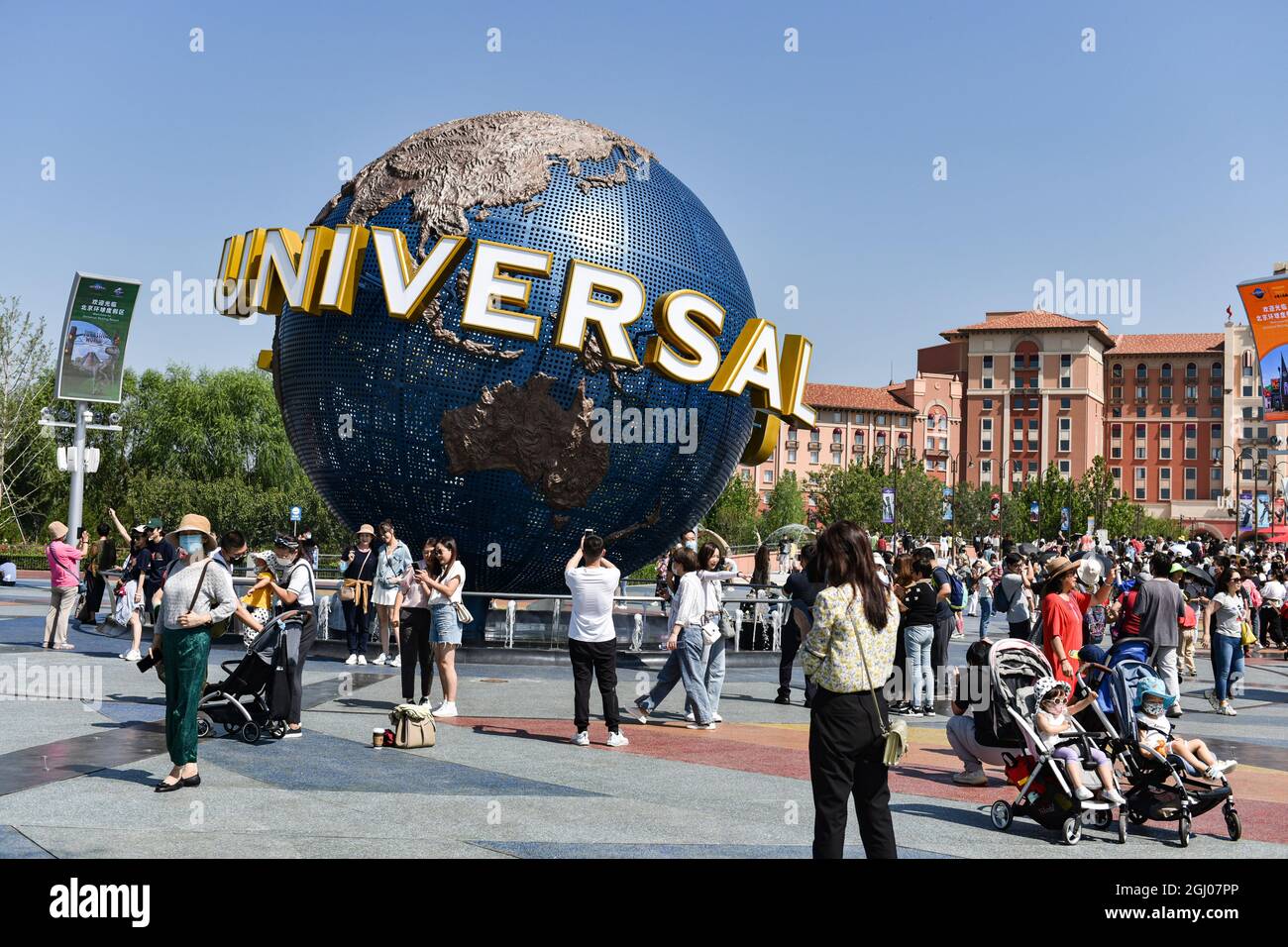 Tourists take pictures in front of the landmark of the universal theme ...