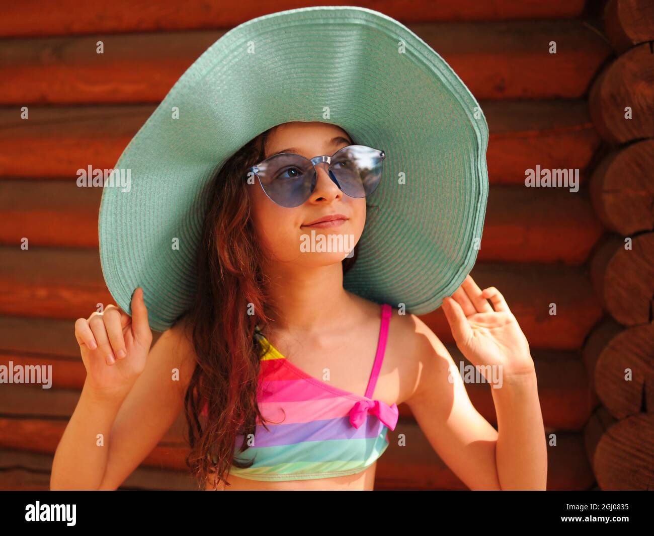 Portrait of a beautiful girl with glasses. Girl in a hat and glasses in ...