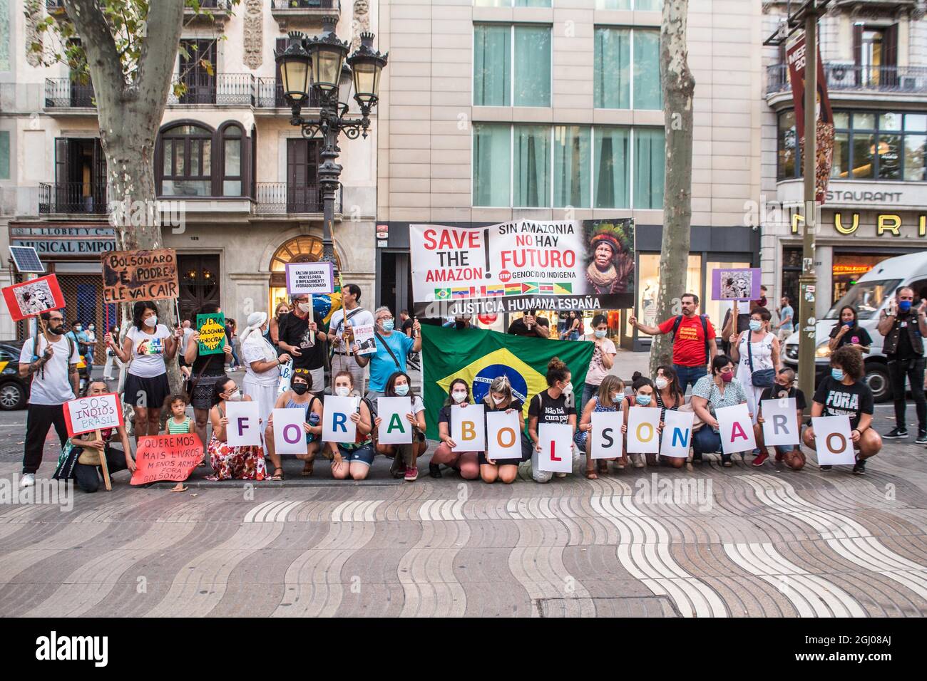 Barcelona, Catalonia, Spain. 7th Sep, 2021. Protesters are seen holding banners that say, out with Bolsonaro and save the amazon! without amazonia there is no future.On the day of the independence of Brazil, September 7, the president of Brazil, Jair Bolsonaro, has summoned his supporters in demonstrations throughout the country and incites threats to democracy and a possible coup d'état. Various groups and political parties in the country have reacted against and called demonstrations against the president, in Barcelona a group of Brazilians have carried out an act against the president Stock Photo