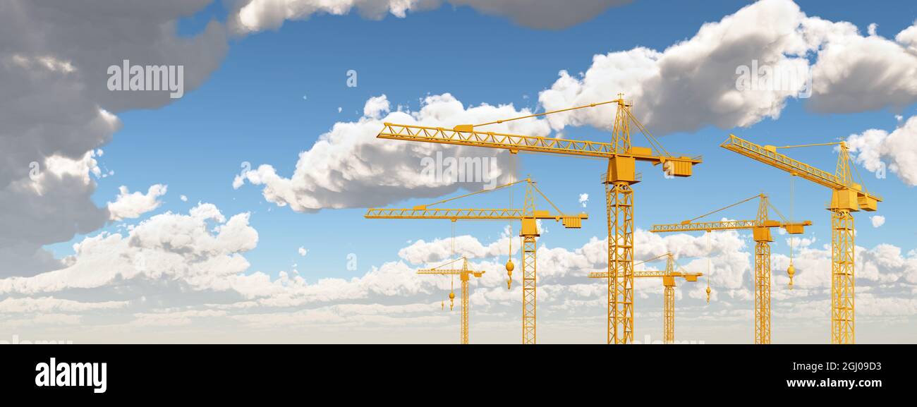 Construction cranes against a blue sky with clouds Stock Photo - Alamy