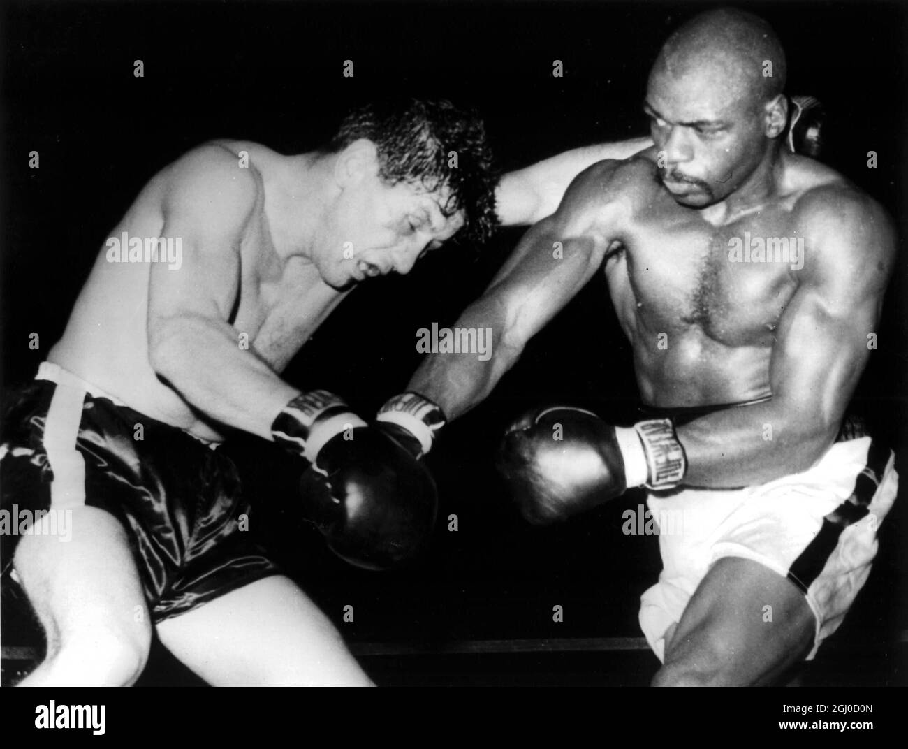 Challenger Rubin '' Hurricane '' Carter tags middleweight championn Joey Giardello with a roundhouse right to the head during their title bout at Convention Hall Giardello was awarded a unanimous decision at the end of fifteen rounds 14th December 1964 Stock Photo