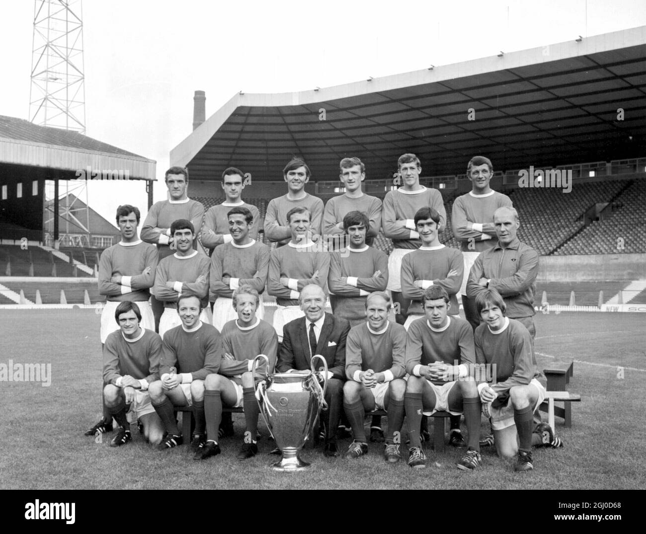The Manchester United Football team of July 26th 1968, seen here with the European Cup that they won after beating Benfica. Back Row L to R,B.Foulkes, J Aston, J. Rimmer, A. Stepney, A. Gowling, D. Head. Centre, D. Sadler, T. Dunne, S. Brennan, P.Crerand, G. Best and F. Burns and trainer J. Crompton. Front, J.Ryan, N. Stiles, D. Law, M. Busby. B. Charlton, B. Kidd and J. Fitzpatrick. Stock Photo