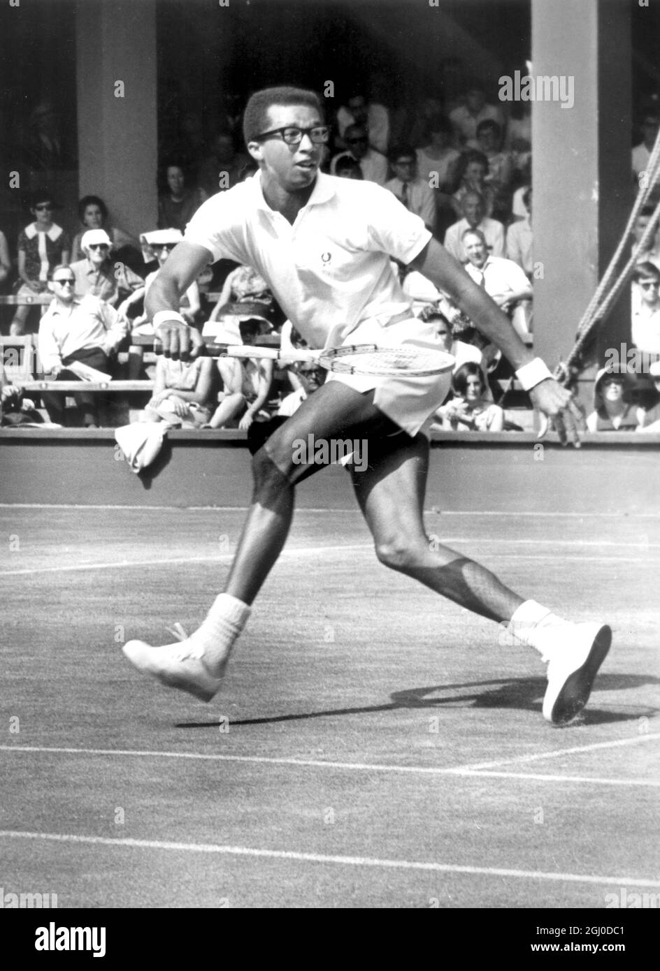 Arthur Ashe in action during his shock 6-4 6-4 4-6 1-6 6-3 victory over fourth seeded John Newcombe of Australia at Wimbledon 1st July 1968 Stock Photo