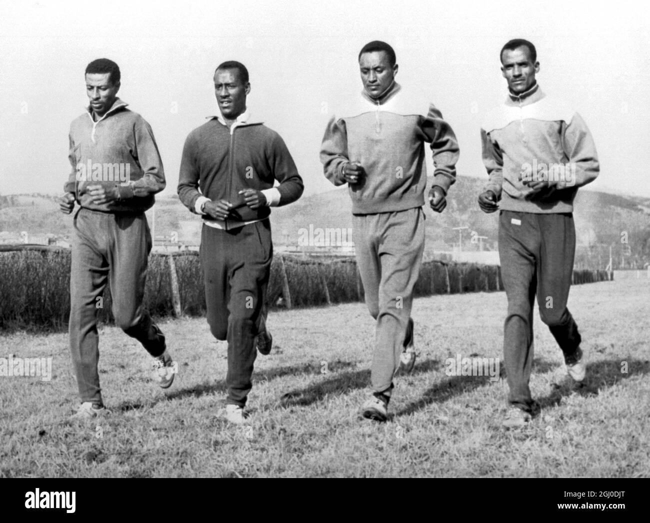 San Sebastian, Spain. Ethiopian long distance runners in traning at this northern Spanish coastal resort for the international cross country contest. Left to right are: Mamo Wolde, Tsegaye Mariam, (trainer) Yitayew, and Abebe Bikila the Olympic marathon champion. 20th January 1964 Stock Photo