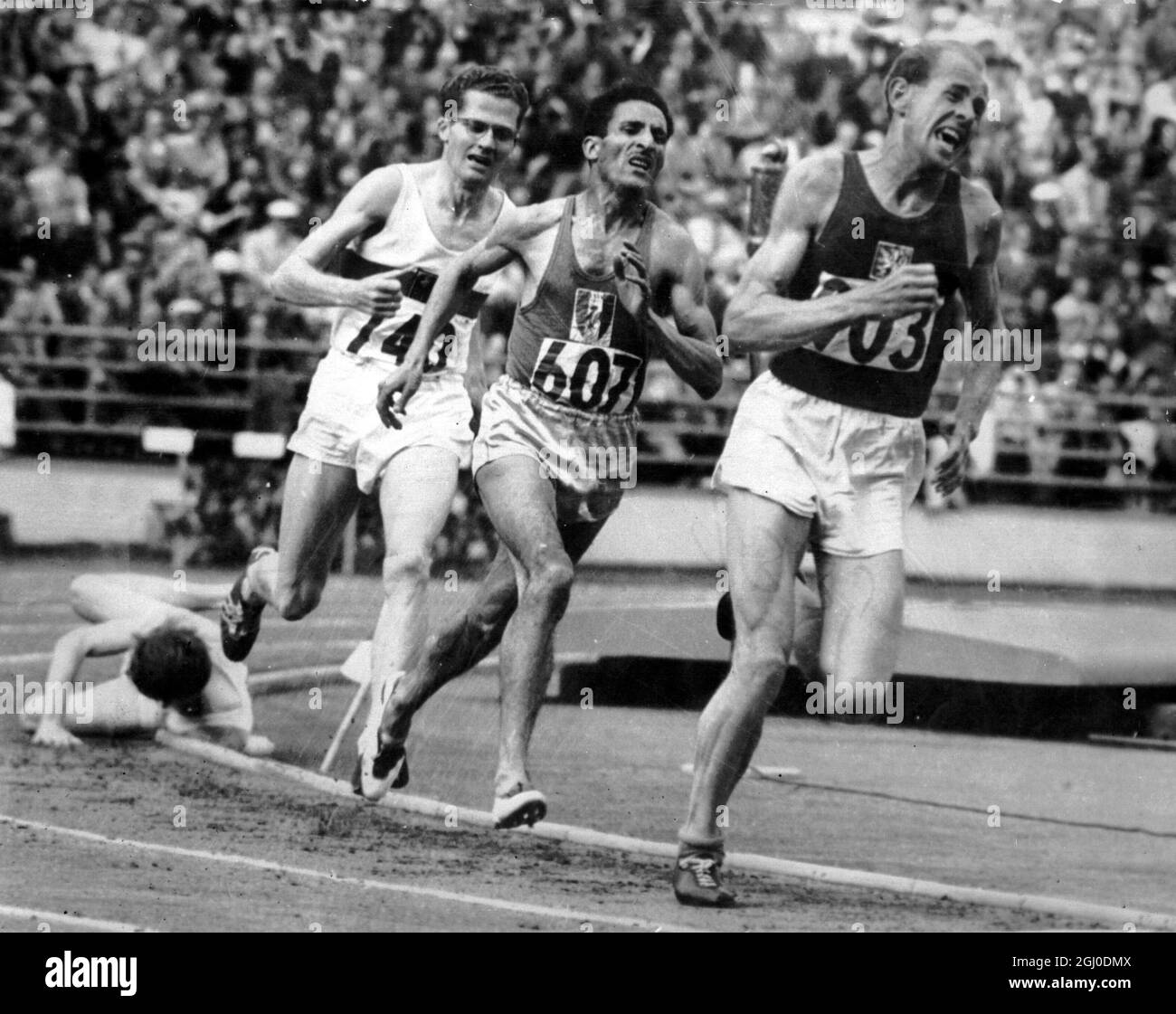 Athletics - Helsinki Olympic Games 1952. Emil Zatopek and countryman Csvona keep fit with a turn