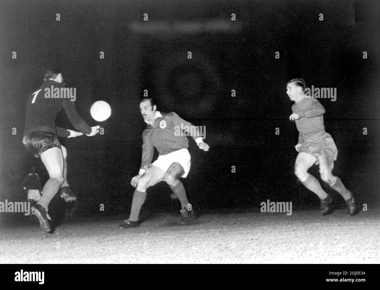 Real Madrid v Benfica Benfica goalkeeper Pereira (left) leaps to collect the ball and foil a Real Madrid attack during the European Cup Final in Amsterdam, Holland. Centre is Benfica's Germano, while right is Ferenc Puskas of Real Madrid, who scored all three goals for his team. Benfica became the European Champions with a 5-3 win. 3rd May 1962. Stock Photo