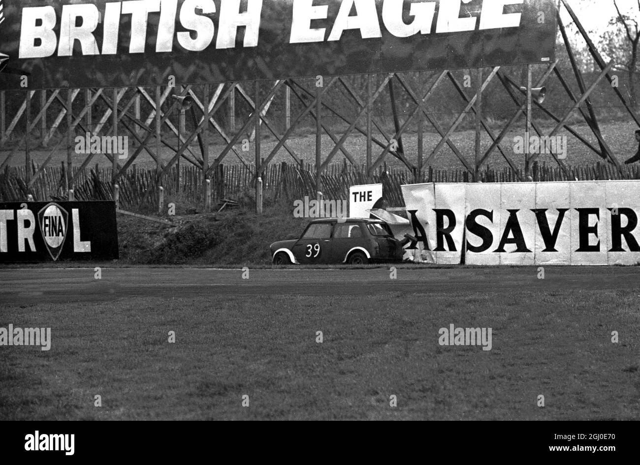 Although the sign says'' The Car Saver'' this Morris Mini Cooper obviously couldn't read as it ploughed straight through. The car , driven by R Jones, was taking part in the Redex Gold Cross Championship Rac ''A'' when it came to grief. Brands Hatch , Kent - 13th November 1967 Stock Photo