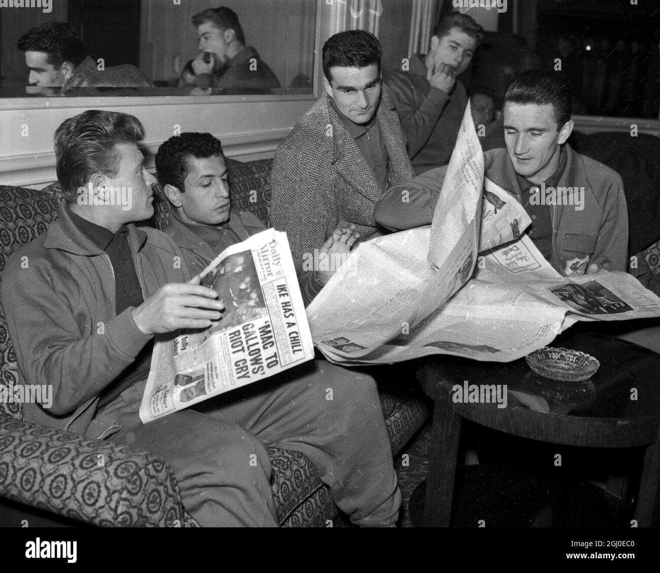 Reading the English newspapers in their hotel this morning after arriving at the hotel last night, are four members of the French football team, Left to Right, S. Bruay; N. Zitovni; R. Piantoni and R. Kaelbel. France are to play England at Wembley tomorrow in an International match. Floodlighting will be used in the later stages of the match if the Russian referee, Mr. N. Latychev, considers them necessary. 26th November 1957. Stock Photo